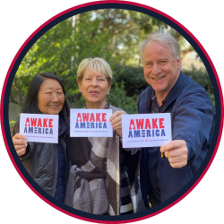 grandparents holding AWAKE America prayer cards